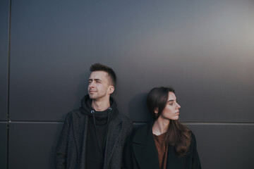 Young loving couple with coffee on black industrial background