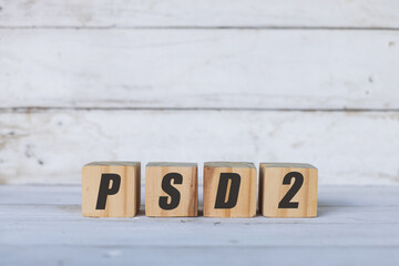 PSD2 concept written on wooden cubes or blocks, on white wooden background.