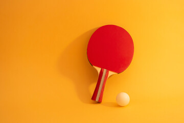 Table tennis racket on yellow background