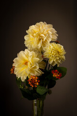 A stunning studio set with yellow Dahlia flowers with small orange flowers to fill taken vintage type lighting perfect for valentines or table to setting or just to brighten a room