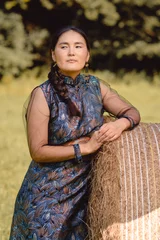 Fotobehang Young Mongolian woman wears traditional deel dress.  © Jan