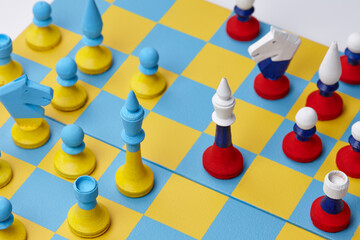 Ukrainian and Russian national colors chess sets on board