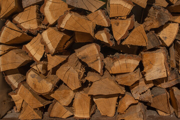 This is a lot of brown firewood. This is a wooden textured background.