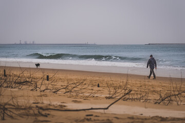 Empty beach and calm sea on a cloudy winter day.