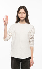 half-length portrait of a young Ukrainian girl who shows the number with her hands on a white background
