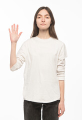 half-length portrait of a young Ukrainian girl who shows the number with her hands on a white background
