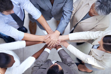 In diversity we will succeed. Shot of a group of coworkers with their hands in a huddle.