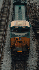 Blue and yellow CSX train in a railyard.  © Kevyn