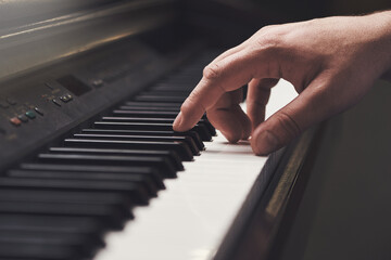 The key to music. Cropped shot of a mans hand on a piano keyboard.