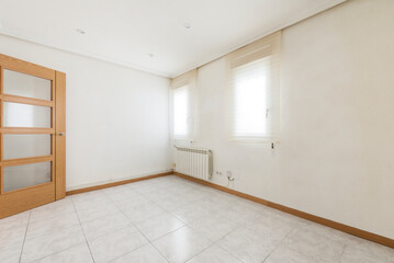 Empty living room with light gloss stoneware floor, two windows, aluminum radiator and oak and...
