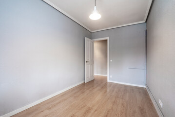 Fototapeta na wymiar Empty room with oak wood floor, gray walls and white woodwork