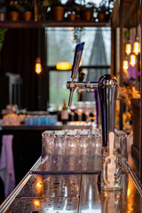 Interior of classic bar with beer taps and empty glasses in cafe