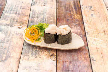 Gunkan sushi of butterfish tacos with japanese rice and salad on white tray