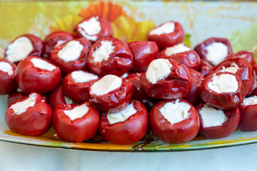 Mediterranean food, sweet red paprika pepper stuffed with soft white cheese