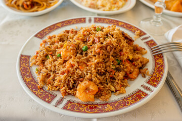 Chinese rice with prawns, vegetables and soy sauce on a decorated plate