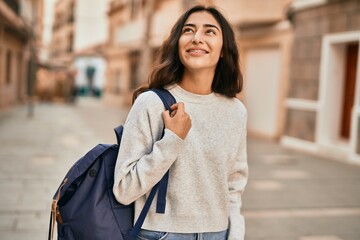 Fototapeta premium Young middle east student girl smiling happy standing at the city.