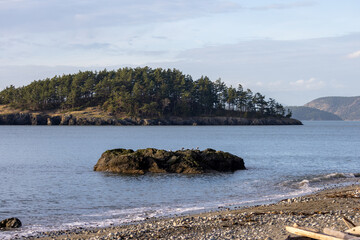 distant forested island off shore from the pacific north west