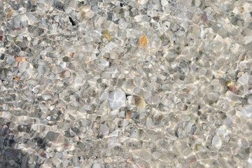 Pebbles in the water with a water reflection, Sandy pattern, Sea background, Pebble texture, Beach background