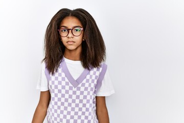 Young african american girl standing over isolated background with serious expression on face. simple and natural looking at the camera.