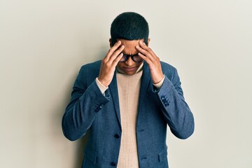 Young handsome hispanic man wearing elegant clothes and glasses with hand on head for pain in head...