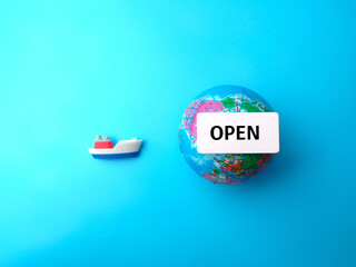 Top view ship and earth globe with text OPEN on blue background.