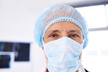 Fototapeta na wymiar Hes ready for surgery. Shot of a mature male surgeoun wearing a surgical mask and cap.
