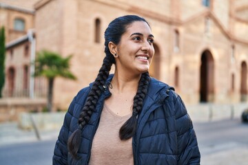 Fototapeta premium Young hispanic woman smiling confident standing at street