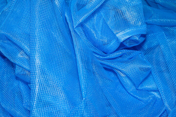 background texture Closeup of blue netting. Abstract background with intersection of nylon threads at high magnification.