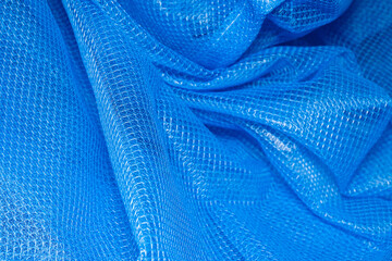 background texture Closeup of blue netting. Abstract background with intersection of nylon threads...