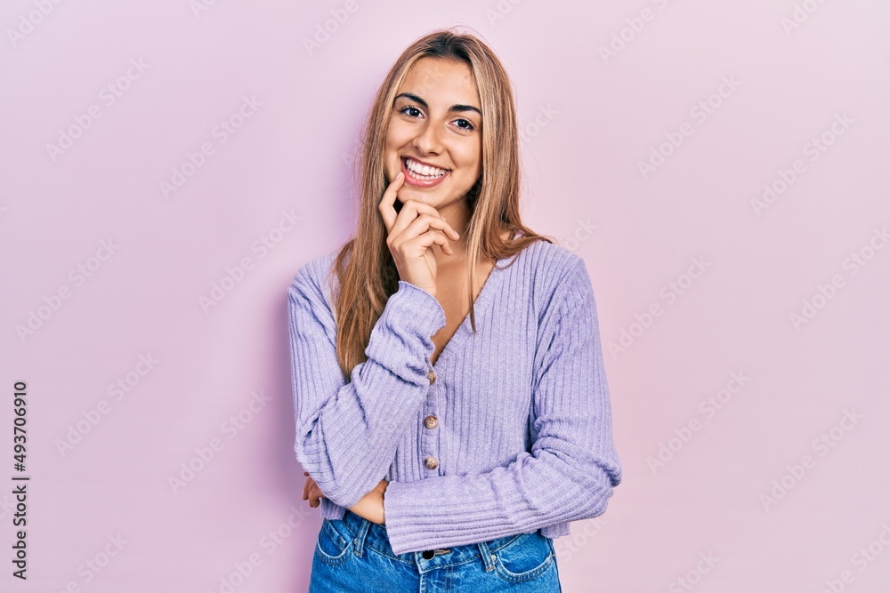 Poster beautiful hispanic woman wearing casual shirt looking confident at the camera with smile with crosse