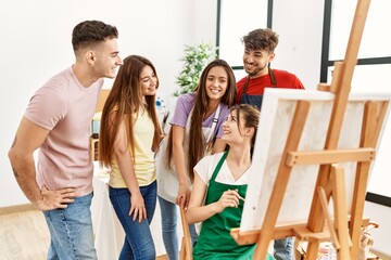Group of people smiling happy and looking draw of partner at art studio.