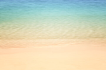 blur of  blue sea and brown sand beach  summer nature wallpaper background