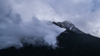 Mountain top in distance with fog.