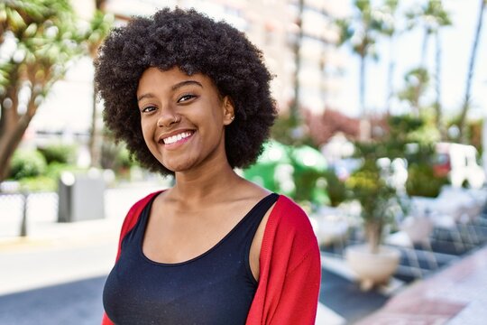 Young african american girl smiling happy standing at the city.