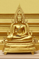 Beautiful of Golden Buddha statue on golden yellow background.
