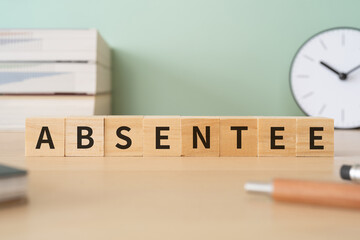 欠席者のイメージ｜「ABSENTEE」と書かれた積み木と本や文房具