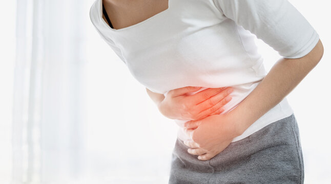 Young woman put her hand on her stomach because she had a very bad stomachache. menstrual pain, gastritis or diarrhoea concept