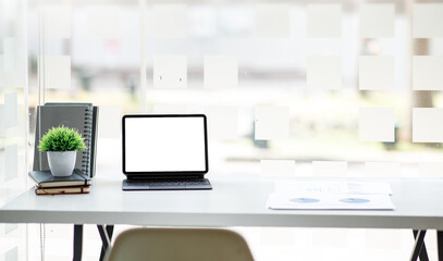 Workspace computer, Laptop Computer with blank screen on white table with note and pen. room interior or office background	
