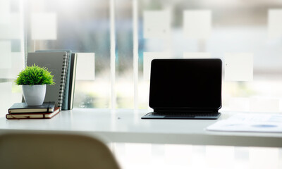 Workspace computer, Laptop Computer with blank screen on white table with note and pen. room interior or office background	
