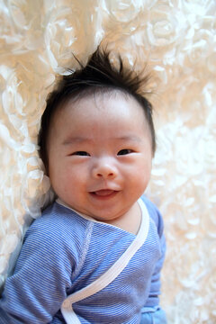 a smiling Asian baby