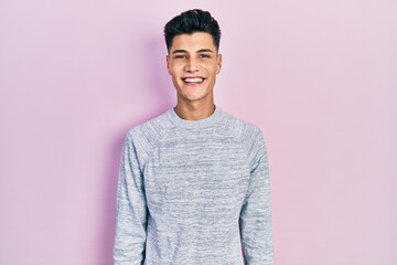 Obraz premium Young hispanic man wearing casual clothes with a happy and cool smile on face. lucky person.