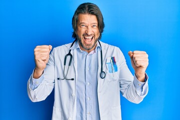 Middle age handsome man wearing doctor uniform and stethoscope celebrating surprised and amazed for...