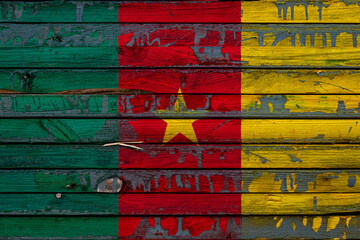The national flag of Cameroon. is painted on uneven boards. Country symbol.