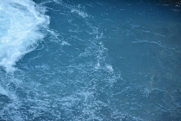Fototapeta na wymiar water surface of a blue river