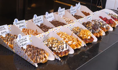 Foto op Plexiglas Delicious traditional Liege waffles with colorful toppings on display in a store window in Brussels, Belgium. Sugary desserts. Typical Belgian sweet food. © BooFamily