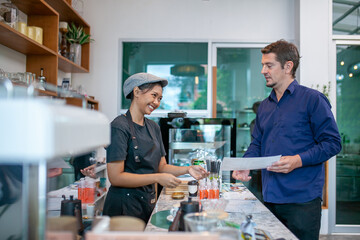 happy barista take order with tablet from customer in coffee shop.