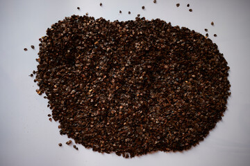 Buckwheat hull isolated on white background. Heap of buckwheat or buckwhein on the Pillow. Organic nature organic photography concept. Buckwheat as a symbol of sustainability
