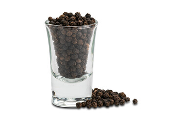 Fototapeta na wymiar Side view pile of black pepper seeds and black peppers seeds in small glass on white background.