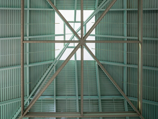 Pale turquoise corrugated Roof with a glass skylight.