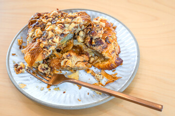 Roasted Hazelnut Coffee Croissant is a delicious homemade bakery on a wooden table. Traditional French breakfasts crispy croissants baked pastries are favorited worldwide.